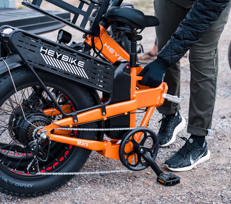 A person folding up their Mars 2 Ebike