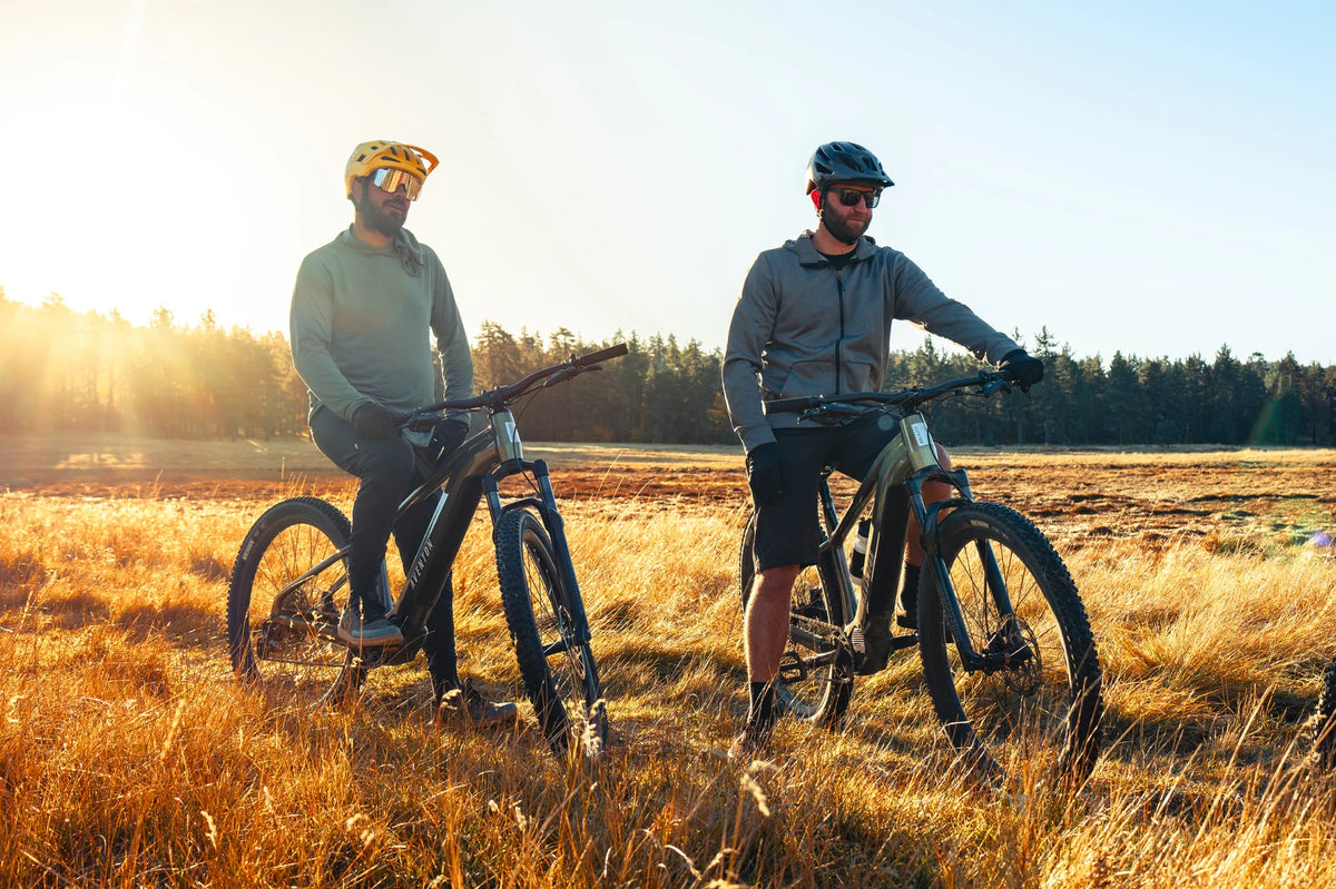 Two men riding their Aventon Ramblas Ebikes on a trail